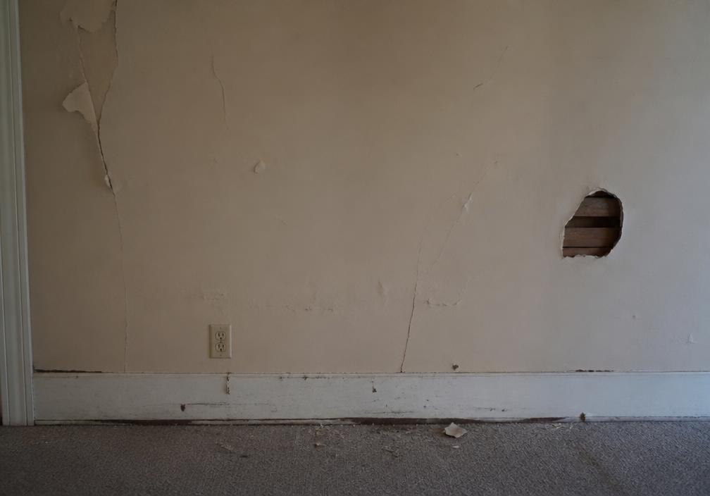Cracked, damaged interior wall before repair